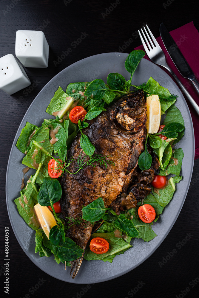 Poster fried carp with salad close up