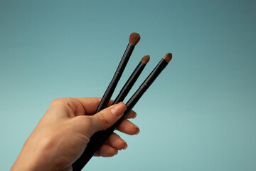 Makeup brushes on a blue background