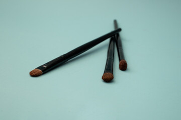 Makeup brushes on a blue background