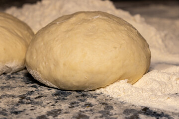 Raw dough with flour on a cutting board. Food photography recipe idea.