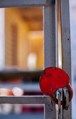 close-up of a heart-shaped iron padlock on a lattice door