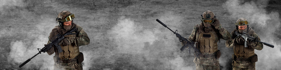 Three mercenary soldiers during a special operation in smoke against a dark concrete wall - photo...