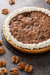 Chocolate Walnut Pie is made with brown sugar, corn syrup and a hint of bourbon closeup in the concrete table. Vertical