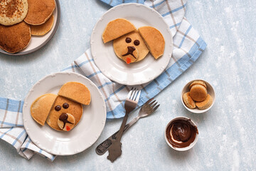 Creative breakfast for children. Funny pancake food art. Banana pancakes in the form of dogs.