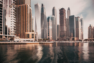 DUBAI, UAE - FEBRUARY 2018: View of modern skyscrapers shining in sunrise lights  in Dubai Marina...