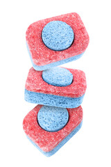 Dishwasher detergent tablets falling on white background