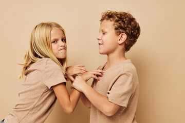 Cute stylish children gesticulate with their hands together Lifestyle unaltered