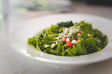Caesar salad is a green salad of romaine lettuce and croutons dressed with lemon juice, olive oil, egg, Worcestershire sauce, anchovies, garlic, Dijon mustard, Parmesan cheese, and black pepper topped