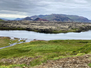 A River in front of a Volcanic Landscape in Iceland