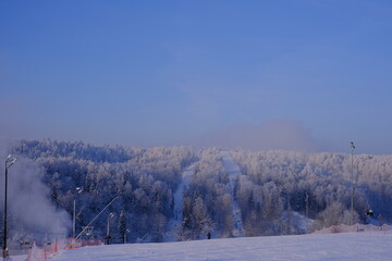 Snow-covered trees in hoarfrost at a ski resort, lift, funicular, ski lift