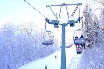 Obraz premium Snow-covered trees in hoarfrost at a ski resort, lift, funicular, ski lift