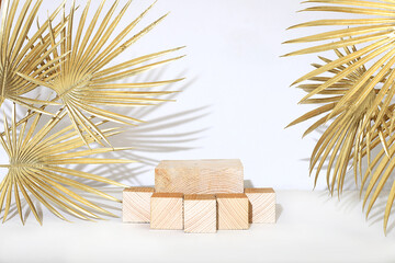 Abstract background with natural wooden podiums and golden palm leaves, empty showcase for showcase...