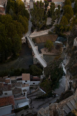 Fototapeta na wymiar Aerial view of a small old medieval village with a bridge over a river.