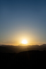 Beautiful sunset over a silhouetted mountain range. 