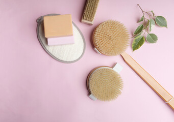 Zero waste eco friendly cleaning concept. wooden brushes on pink background with natural soap