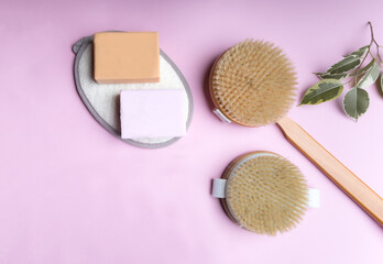 Zero waste eco friendly cleaning concept. wooden brushes on pink background with natural soap