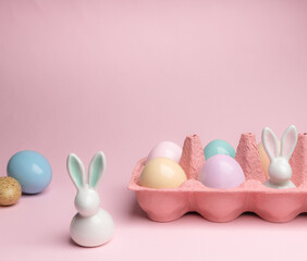 Shot of arrangement decoration Happy Easter holiday on a pink background.Colorful Easter eggs in paper box. Copy space.