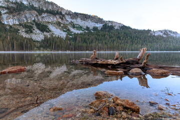 Fototapeta na wymiar Reflecting Lake by Mountainside in Yosemite National Park California During a Foggy Morning