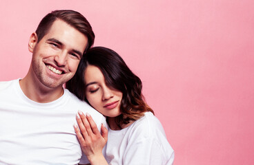 Fototapeta premium young cheerful caucasian couple together having fun on pink background, guy ang girl modern relationship, lifestyle people concept