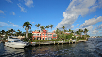 Fototapeta na wymiar Beautiful pink waterfront home on the Intracoastal Waterway in Fort Lauderdale, Florida, USA. 