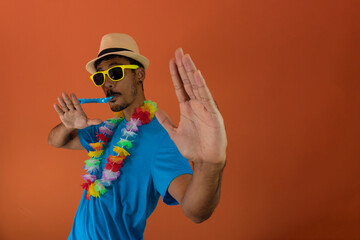 Black man in costume for brazil carnival isolated on orange background. African man in various poses and expressions.