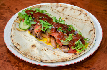 Shaorma shawarma kebab on a plate before being wrapped - burrito