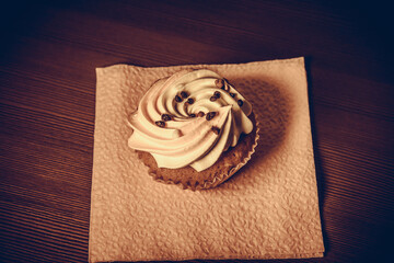 Cake on a napkin, on a dark table.