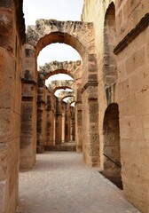 Ancient roman amphitheatre in El Jem, Tunisia, Africa. Antique yellow and grey stone arches