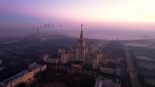 Footage of Moscow State University during sunrise in foggy day