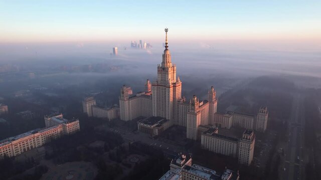Footage of Moscow State University during sunrise in foggy day