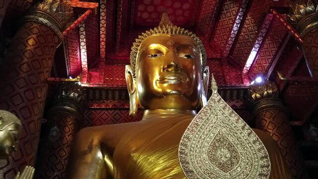 The ancient, highly revered gilded Buddha statue dating from 1334 CE at Wat Phanan Choeng temple in Ayutthaya, Thailand. 