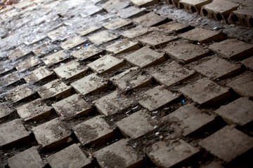 A paved path under a bridge in an old part of town.