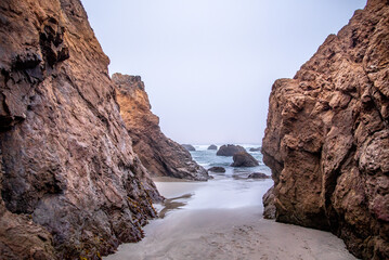 View Through Rocky formations into the Pacific Ocean from the California Coast on a Cloudy Day