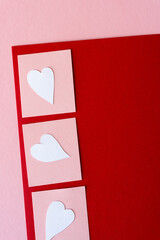 white hearts and pink squares on red and pink paper