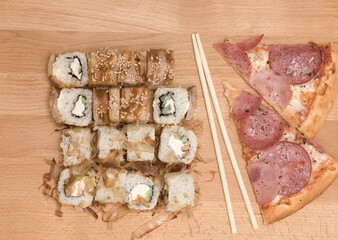 pizza and rolls on a wooden background. fast food.