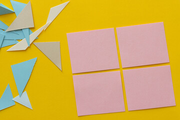 paper background with pink paper squares and triangles