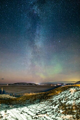 Fototapeta na wymiar milky way over icelandic winter scene with small aurora