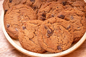 Butter cookies in wooden plate on wooden background, Chocolate Chip Cookies ready to serve.