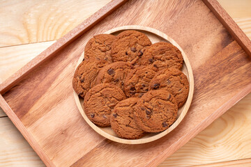 Butter cookies in wooden plate on wooden background, Chocolate Chip Cookies ready to serve.