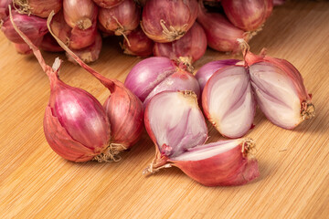 Shallots or Red Onion, Asian herbs and cooking ingredients on wooden background.