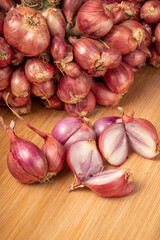 Shallots or Red Onion, Asian herbs and cooking ingredients on wooden background.