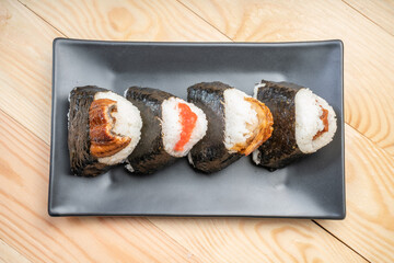 Onigiri or Japanese seaweed rice triangles shaped Stuffed with grilled eel, scallop, plum and fish roe, Japanese Rice Balls  famous food.