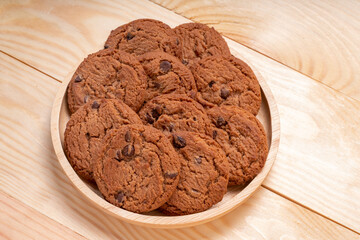 Butter cookies in wooden plate on wooden background, Chocolate Chip Cookies ready to serve.
