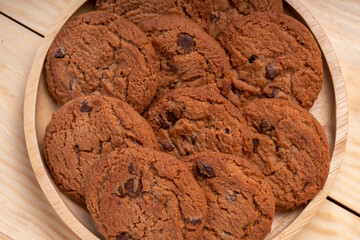 Butter cookies in wooden plate on wooden background, Chocolate Chip Cookies ready to serve.