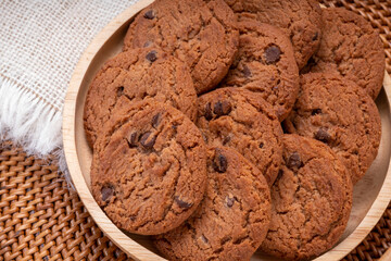 Butter cookies in wooden plate on wooden background, Chocolate Chip Cookies ready to serve.