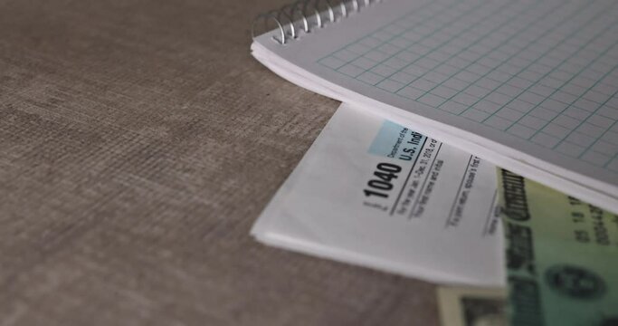 Economic stimulus tax return check and US 100 dollar bills currency