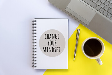 Positive motivational words on a book - Change your mindset. A flat lay concept with cup of coffee,...