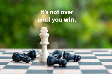 Inspirational motivational quote - It's not over until you win. With king and black pawn chess...