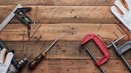 Collection of woodworking tools on a wooden background.