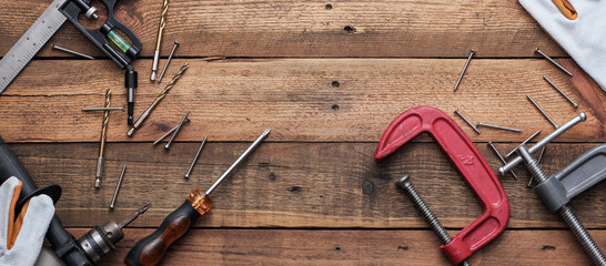 Collection of woodworking tools on a wooden background.